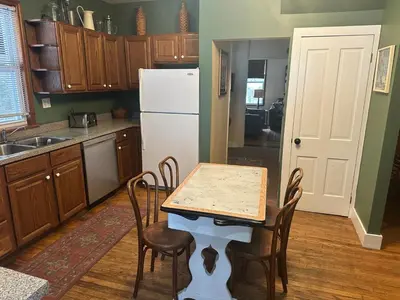 a kitchen with a table and chairs and a refrigerator at Charming Four Bedroom House in Tannersville