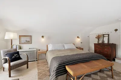 a bedroom with a bed and a chair and a desk at Gorgeous Hudson Valley Farmhouse on 14 Acres home in Old Chatham