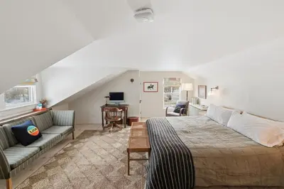 a living room with a bed and a couch at Gorgeous Hudson Valley Farmhouse on 14 Acres home in Old Chatham