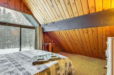 a bedroom with a bed and a large window at Ski, Hike and More! Year-Round Retreat in West Dover in West Dover