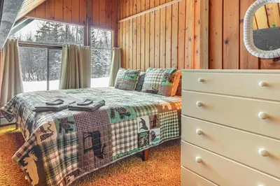 a bedroom with a bed and a dresser and a window at Ski, Hike and More! Year-Round Retreat in West Dover in West Dover
