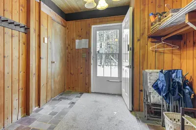 a hallway with a door in a wooden wall at Ski, Hike and More! Year-Round Retreat in West Dover in West Dover