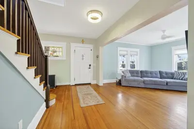 an open living room with a couch and wooden floors at 14 Guest, 9 Bed, Family Getaway- 30 min from NYC in New Rochelle