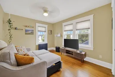 a living room with a couch and a flat screen tv at 14 Guest, 9 Bed, Family Getaway- 30 min from NYC in New Rochelle