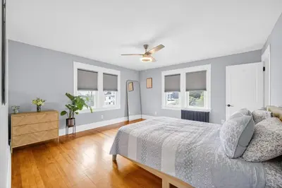 a bedroom with a bed and a ceiling fan at 14 Guest, 9 Bed, Family Getaway- 30 min from NYC in New Rochelle