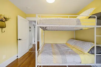 a bedroom with two bunk beds in a room at 14 Guest, 9 Bed, Family Getaway- 30 min from NYC in New Rochelle