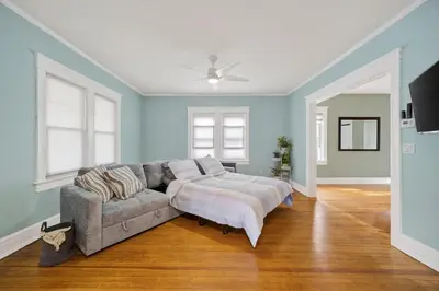 a living room with a couch and a ceiling fan at 14 Guest, 9 Bed, Family Getaway- 30 min from NYC in New Rochelle