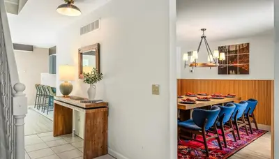 a dining room with a table and blue chairs at Epic Poconos Pad - Pool - Hot Tub - Gym - Golf Sim in East Stroudsburg