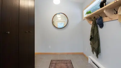 a hallway with a mirror on the wall at Catskills Mountain Home Near Windham w Fireplace Open Living Deer Run Lodge by AvantStay in Prattsville