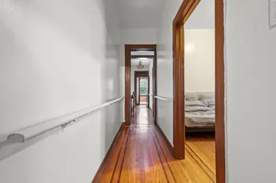 a hallway with a mirror and a bed in a room at Massive NYC House with Pool Table in Yonkers