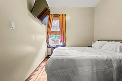 a bedroom with a bed and a window at Massive NYC House with Pool Table in Yonkers
