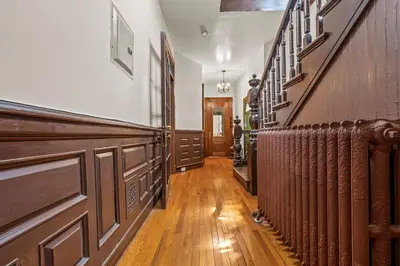 a hallway with wood paneling and a row at Massive NYC House with Pool Table in Yonkers