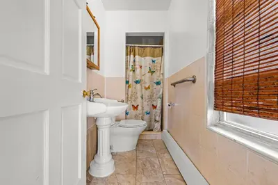 a bathroom with a toilet and a sink at Massive NYC House with Pool Table in Yonkers