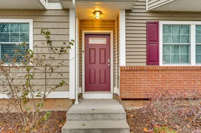 a purple door on a house with a brick at 2 Mi to The Mark Twain House and Museum Airy Escape in West Hartford