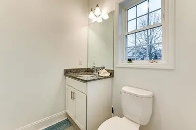 a bathroom with a toilet and a sink and a window at 2 Mi to The Mark Twain House and Museum Airy Escape in West Hartford