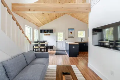 a living room with a couch and a table at Berkshire House in Hillsdale