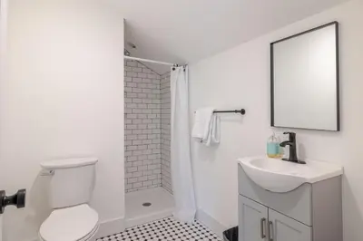 a white bathroom with a toilet and a sink at Berkshire House in Hillsdale