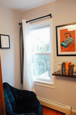 a window in a room with a blue chair next to it at Hot Tub, 2 Blocks to Downtown Saugerties, Sleeps 8 in Saugerties