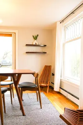 a dining room with a table and chairs and a window at Hot Tub, 2 Blocks to Downtown Saugerties, Sleeps 8 in Saugerties