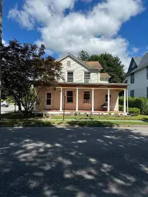 a white house with a tree in front of it at Hot Tub, 2 Blocks to Downtown Saugerties, Sleeps 8 in Saugerties