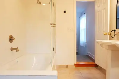 a bathroom with a shower and a tub and a sink at Hot Tub, 2 Blocks to Downtown Saugerties, Sleeps 8 in Saugerties
