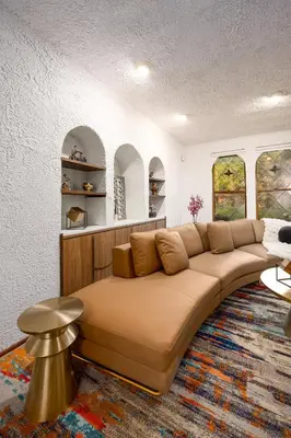a living room with a large brown couch at Mansion of Belleayre Mountain! POOL, SAUNA, Game Room in Fleischmanns