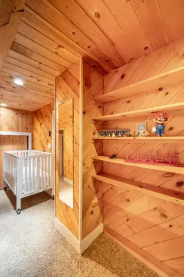 a log cabin with a crib in a room at Mansion of Belleayre Mountain! POOL, SAUNA, Game Room in Fleischmanns