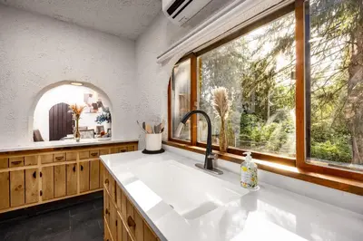 a kitchen with a sink and a large window at Mansion of Belleayre Mountain! POOL, SAUNA, Game Room in Fleischmanns