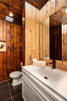 a bathroom with a white tub and a toilet at Mansion of Belleayre Mountain! POOL, SAUNA, Game Room in Fleischmanns