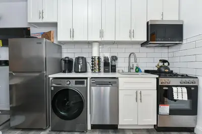 a kitchen with a dishwasher and a washer at Cozy 1BR in Central Manhattan W Private Terrace in New York