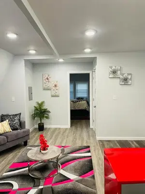 a living room with a couch and a table at Xceptional homes in East Orange