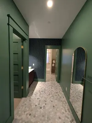 a bathroom with green walls and a sink and a mirror at Parkway House Goshen Bed And Breakfast Suite 2 in Goshen