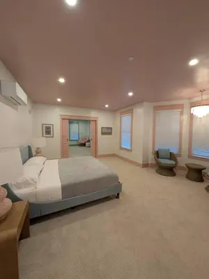 a large bedroom with a bed and a chair at Parkway House Goshen Bed And Breakfast Suite 1 in Goshen
