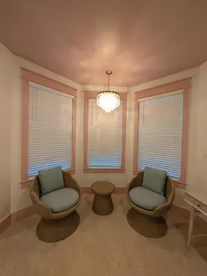 a living room with two chairs and a piano at Parkway House Goshen Bed And Breakfast Suite 1 in Goshen