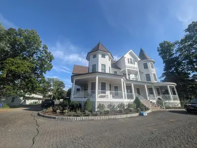 a large white house with a turret at Parkway House Goshen Bed And Breakfast Suite 4 in Goshen