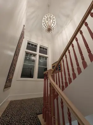 a staircase in a house with a chandelier at Parkway House Goshen Bed And Breakfast Suite 5 in Goshen