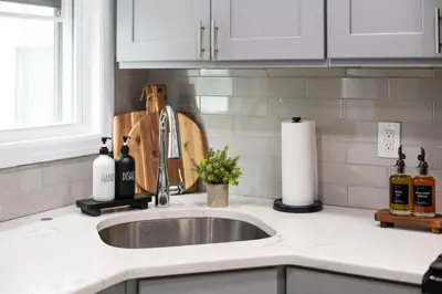 a kitchen counter with a sink and a window at The Harper Loft in Hoboken