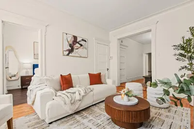 a white living room with a couch and a table at The Caleb Loft in Hoboken