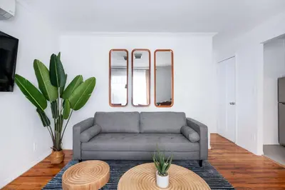 a living room with a couch and a table at 26-1C Gramercy Large 1BR WD in New York