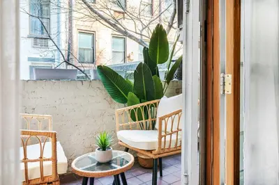 a balcony with a chair and a table and some plants at 26-1C Gramercy Large 1BR WD in New York