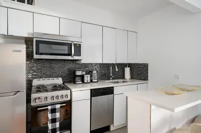 a kitchen with a stove and a microwave at 26-1C Gramercy Large 1BR WD in New York
