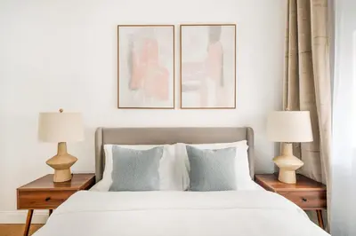 a bedroom with a bed with two lamps on tables at 26A-2 Spacious brand new Fully Furnished 2-Bedroom in Prime Murray Hill Move-In Ready in New York