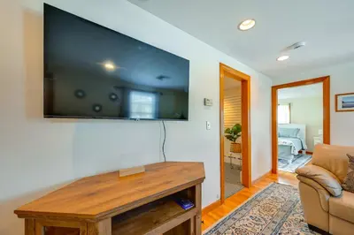 a living room with a large flat screen tv on a wall at Heart of Five College Consortium! Hadley Home in Hadley