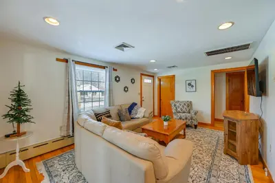 a living room with a couch and a christmas tree at Heart of Five College Consortium! Hadley Home in Hadley