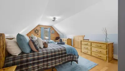 a bedroom with a bed and a wooden dresser at Amazing Views Hot Tub Fire Pit Game Room in Ashland