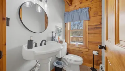 a bathroom with a white sink and a mirror at Amazing Views Hot Tub Fire Pit Game Room in Ashland