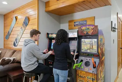 a man and a woman playing a video game at Amazing Views Hot Tub Fire Pit Game Room in Ashland