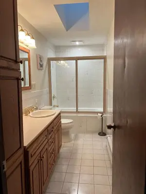 a bathroom with a sink and a toilet and a window at Perfect Family Retreat in East Haven in East Haven