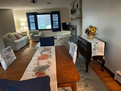 a living room with a dining table and a living room with a couch at Perfect Family Retreat in East Haven in East Haven