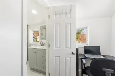 an open door to a kitchen with a laptop computer at Family Retreat Near NYC w/ Parking & Views in Hackensack